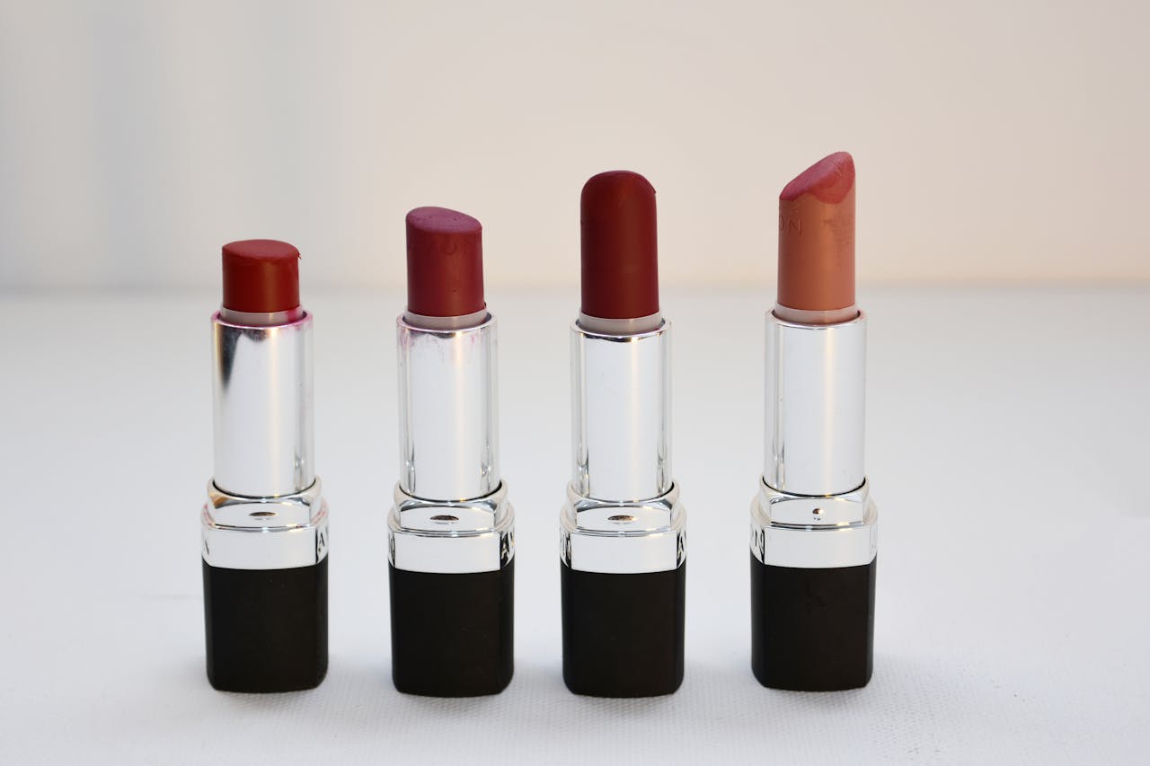 Four different shades of lipsticks arranged neatly, perfect for beauty content.