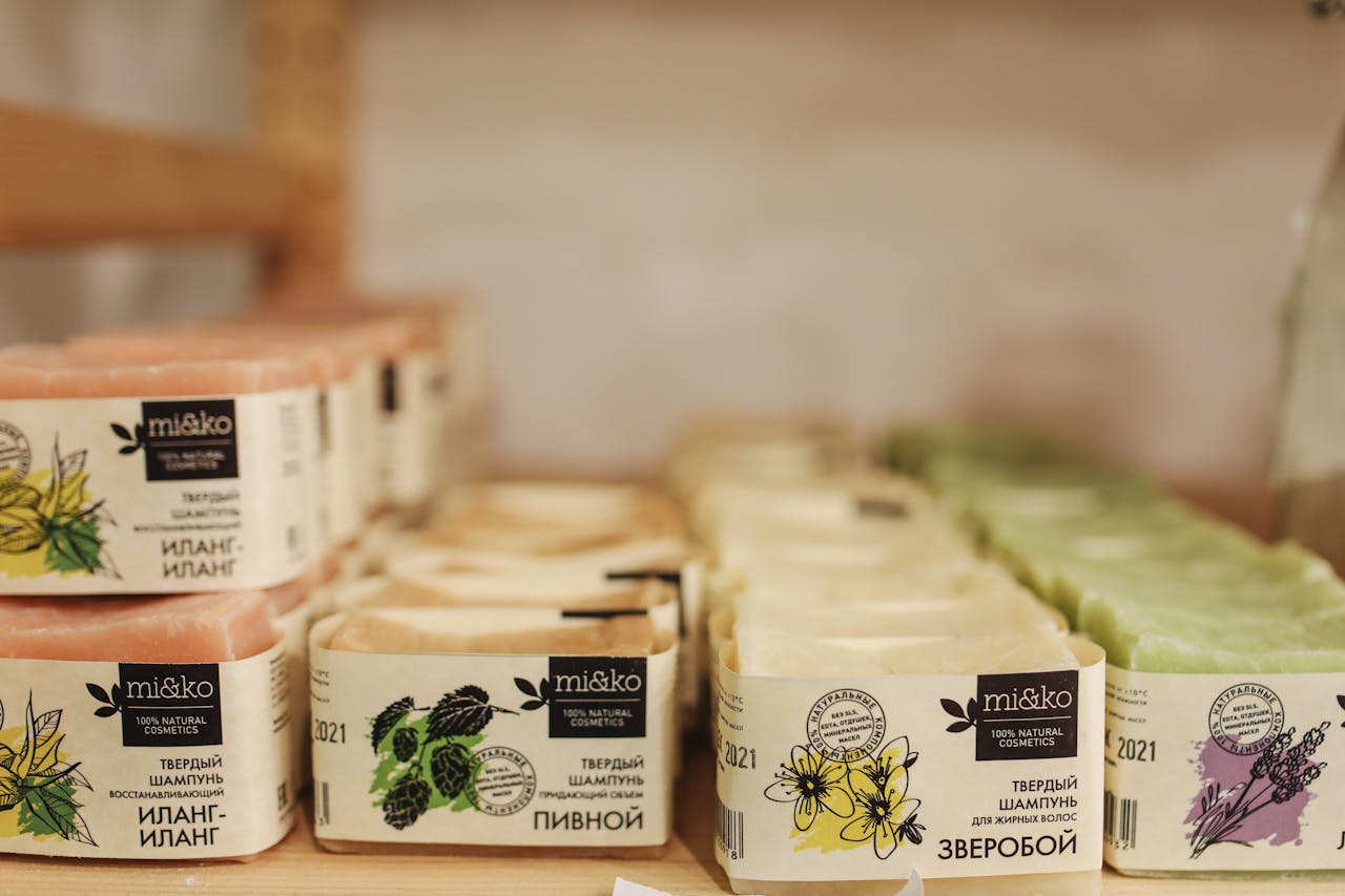 A selection of natural skincare products, including soaps, is neatly organized indoors for sale.